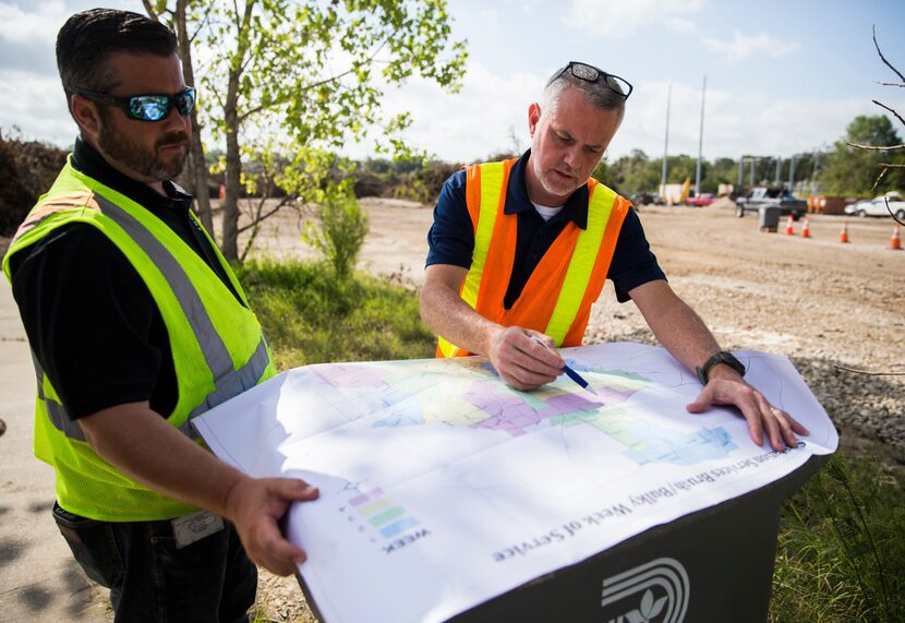 Tim Oliver (left), assistant director of Sanitation Services for the city of Dallas, and...