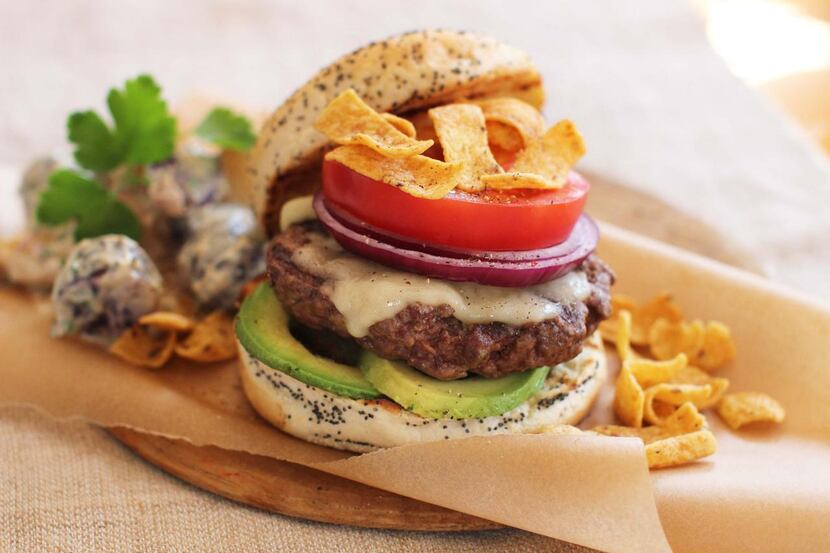 
The California Dreaming Burger has cheese, avocado, tomato, red onion and chips. 
