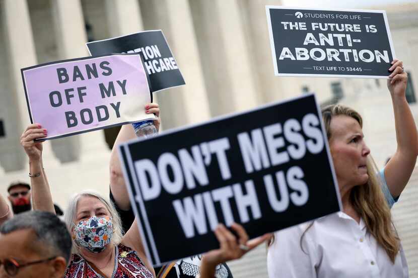 WASHINGTON, DC - OCTOBER 04: Pro-choice and anti-abortion activists protest alongside each...
