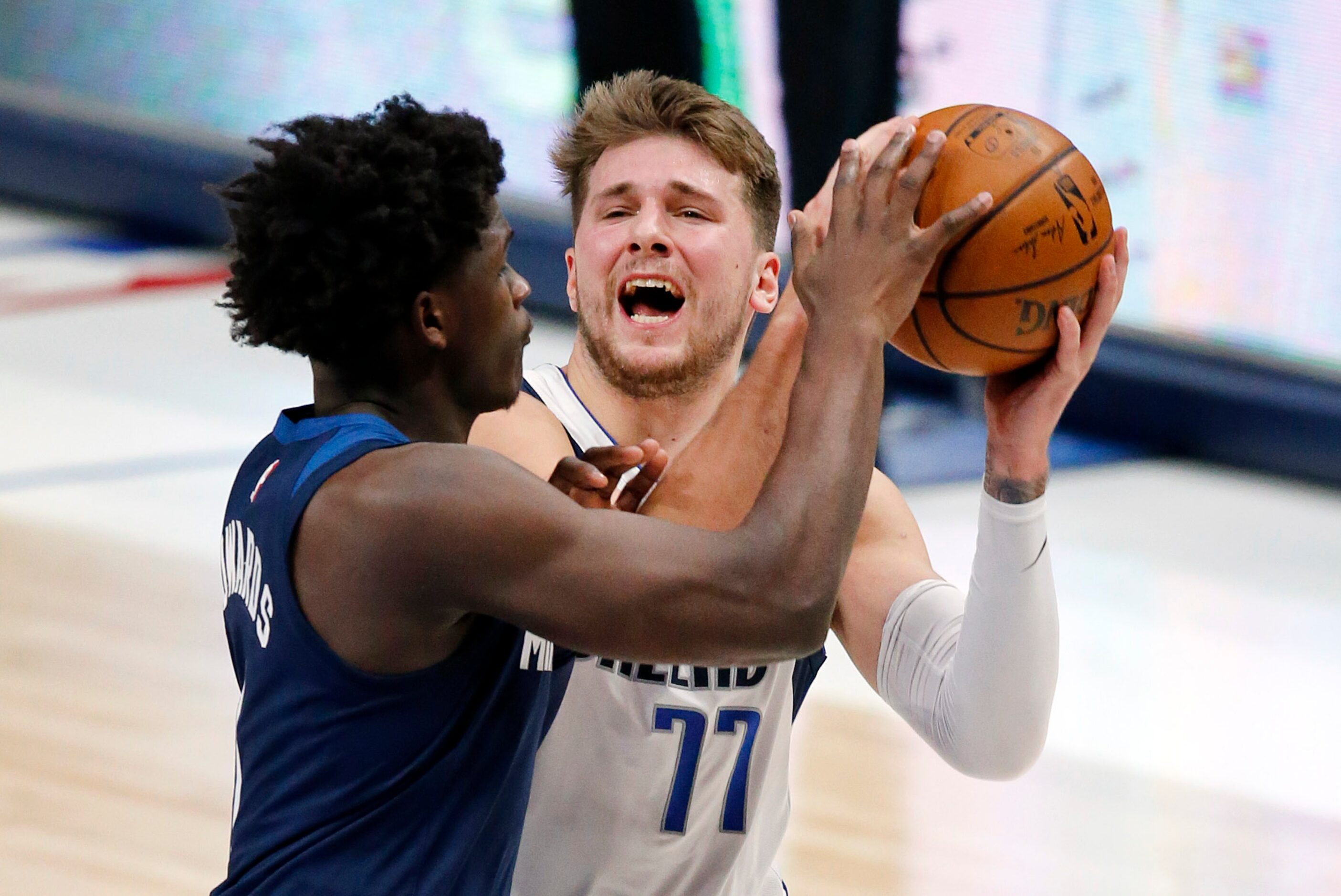 Dallas Mavericks guard Luka Doncic (77) battles with Minnesota Timberwolves Anthony Edwards...