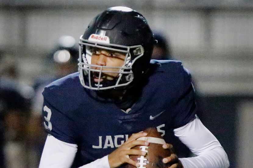 Flower Mound High School quarterback Nick Evers (3) rolls out of the pocket during the first...