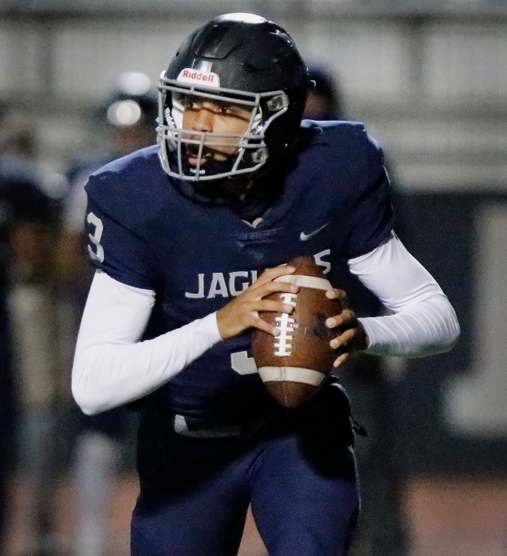 Flower Mound High School quarterback Nick Evers (3) rolls out of the pocket during the first...