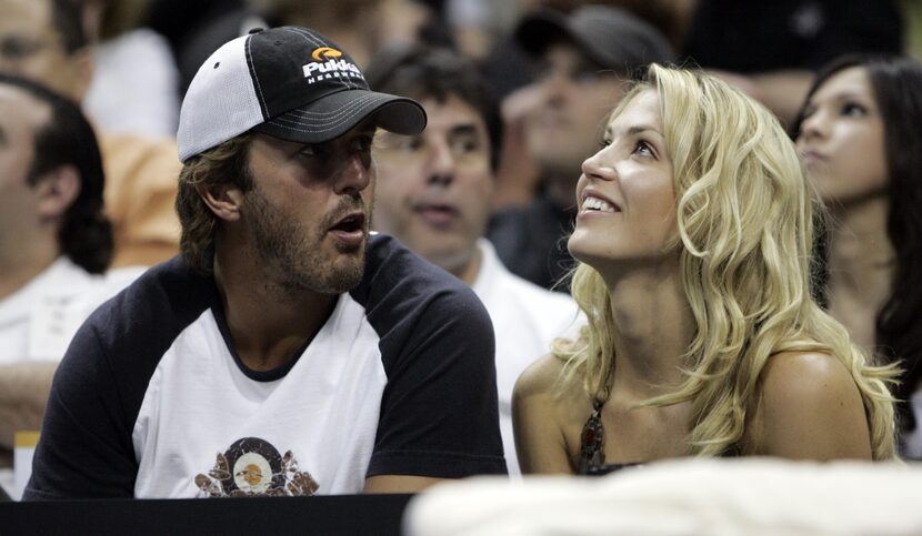 Dallas Stars Mike Modano sits with a friend Willa Ford during the first half of Game 7 of...