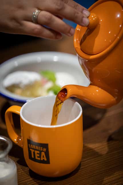 A diner pours a cup of tea at Fish & Fizz.