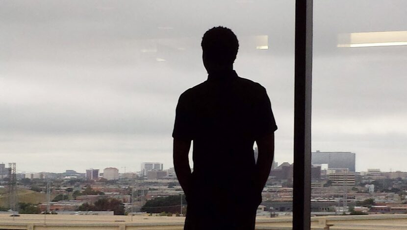 Johnson peers at the Dallas skyline at a court appearance in August 2014, a year before he...