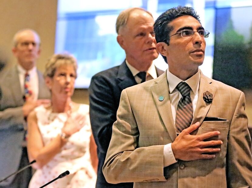 Bhojani recites the pledge of allegiance before his swearing-in. 