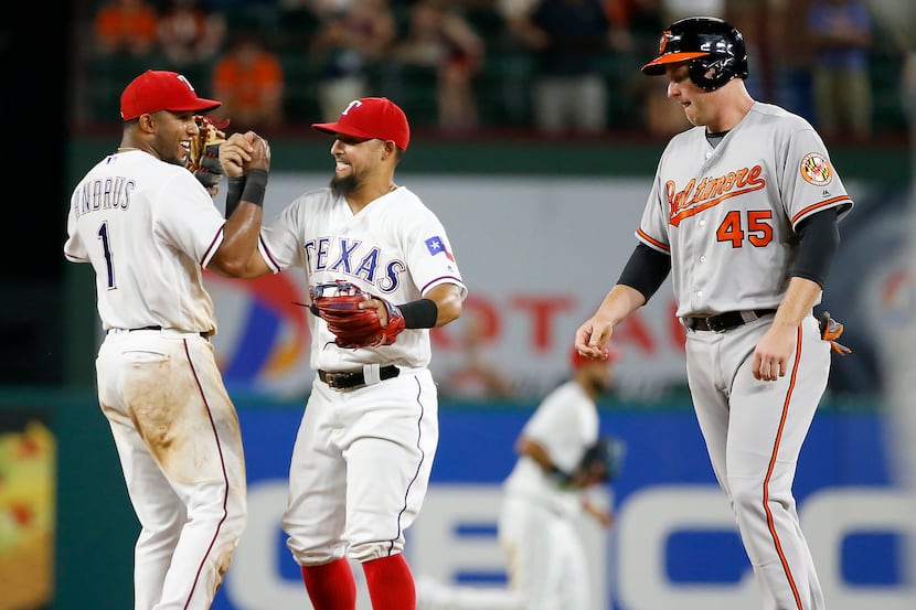 Rangers shortstop Elvis Andrus (1) celebrates a 4-3 win over Baltimore with second baseman...