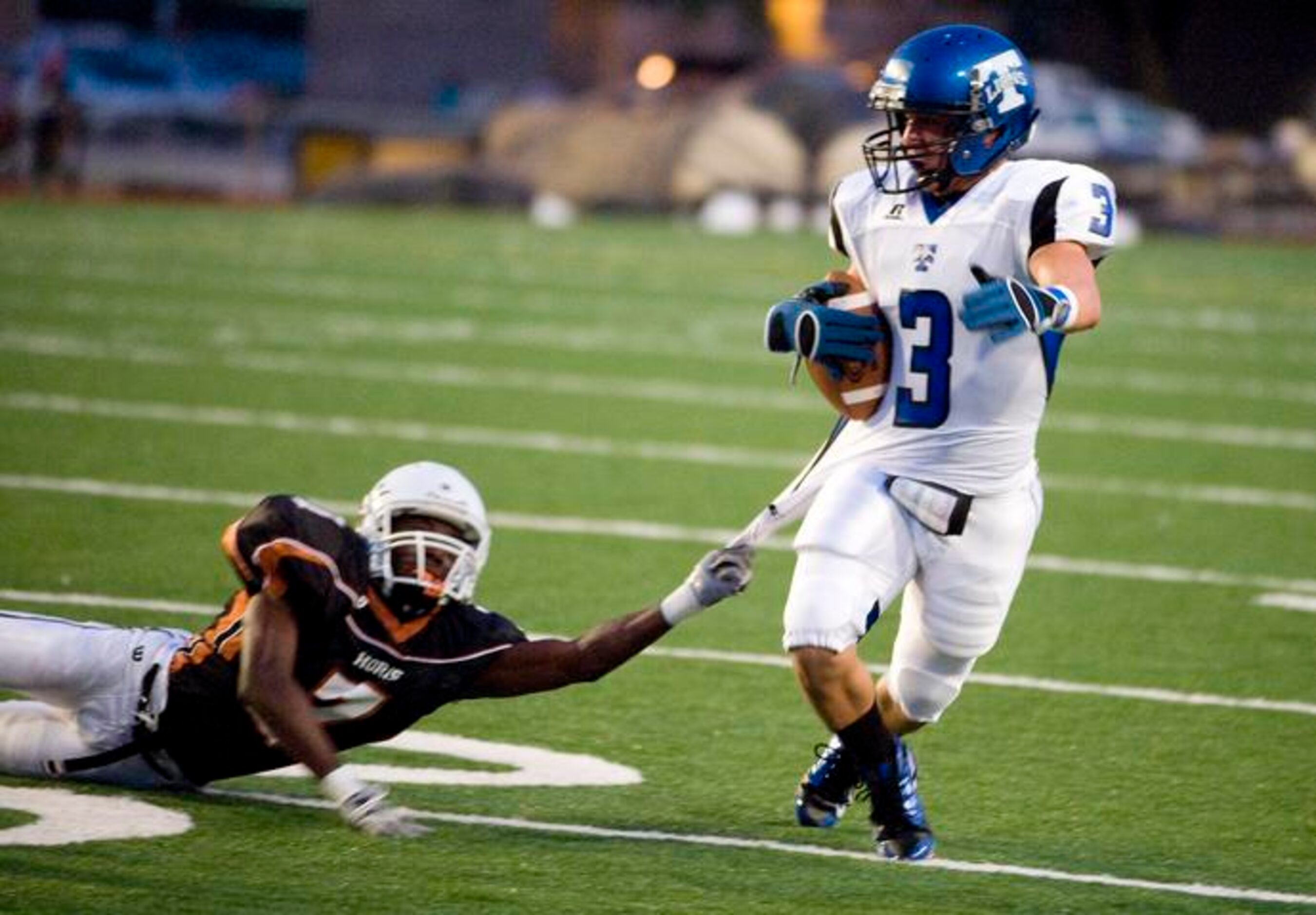 R.L. Turner receiver Matthew Bernal tries to pull away from W.T. White defensive back Lester...