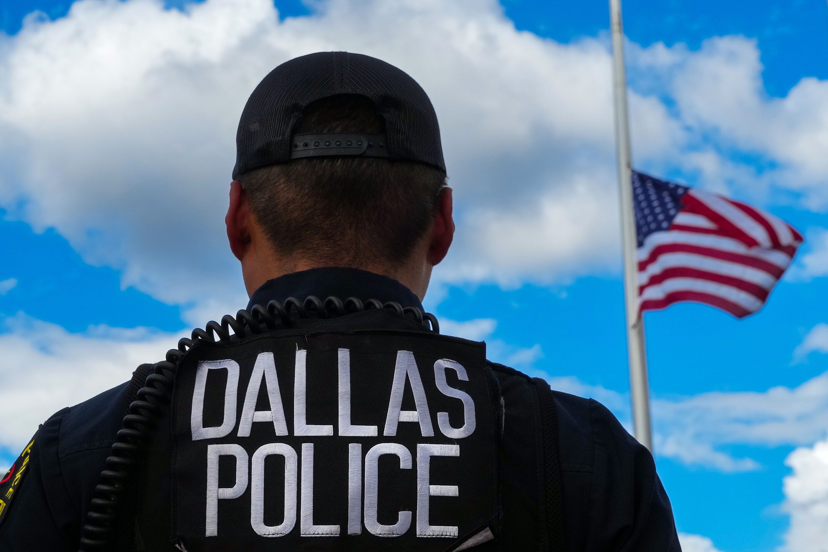 The flag flies half staff during a vigil for slain Dallas police officer Darron Burks...