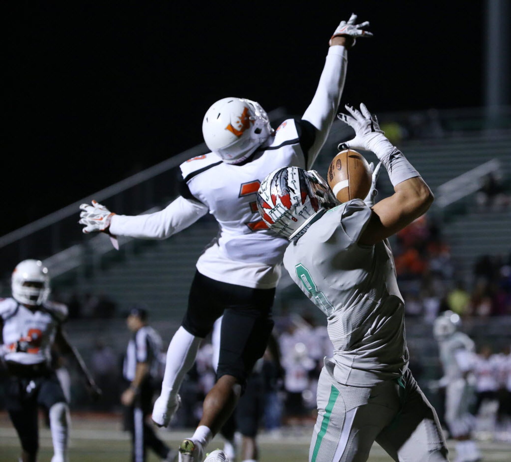 Waxahachie wide receiver Devan Brady (8) catches a pass over Kenan Ivy (3) in the first...