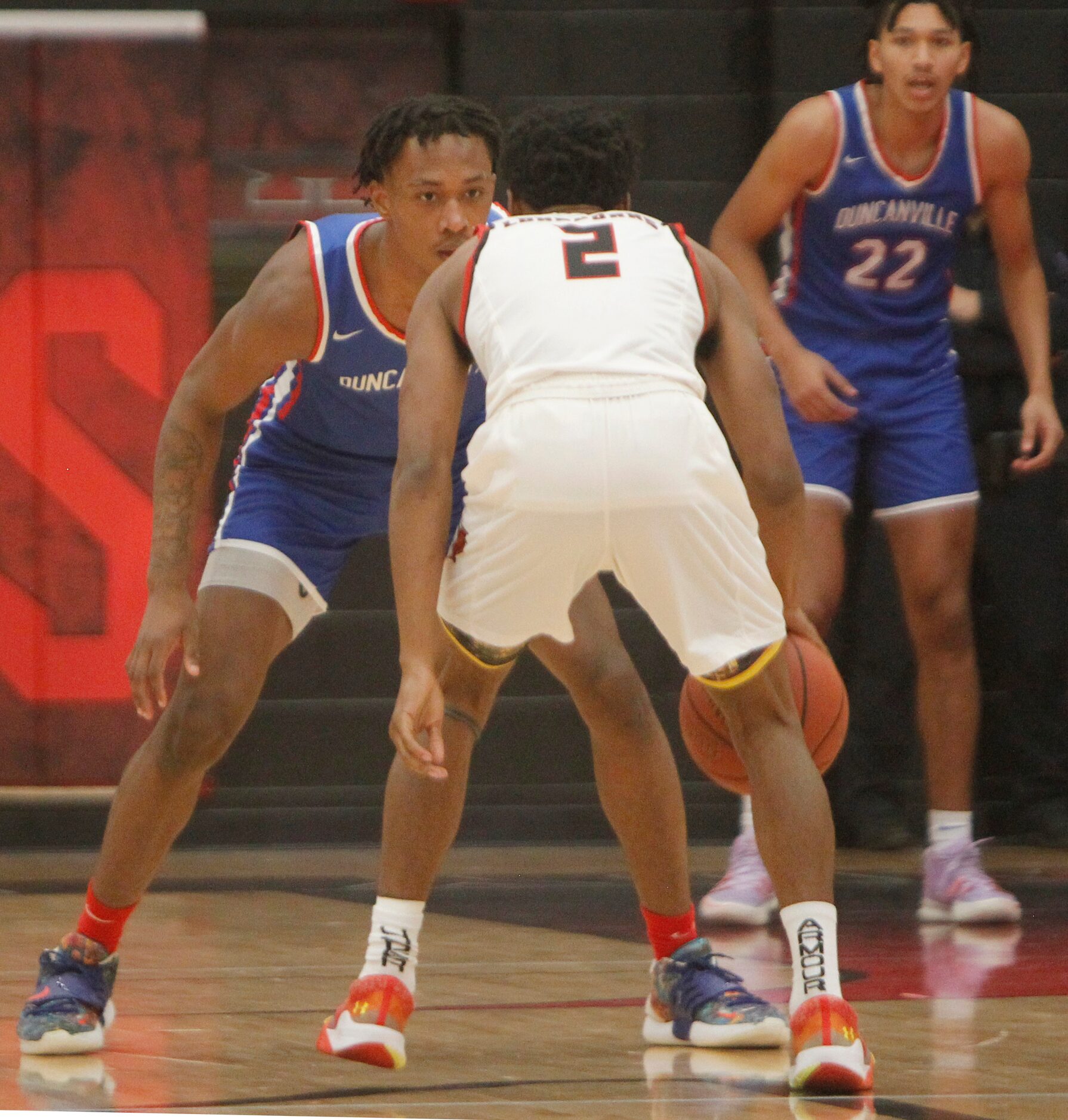 Duncanville forward Ronald Holland (1), left, eyes the moves of Cedar Hill's Jason justice...