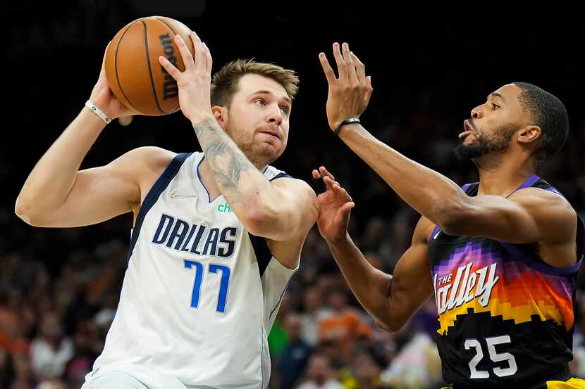 Dallas Mavericks guard Luka Doncic (77) drives on Phoenix Suns forward Mikal Bridges (25)...