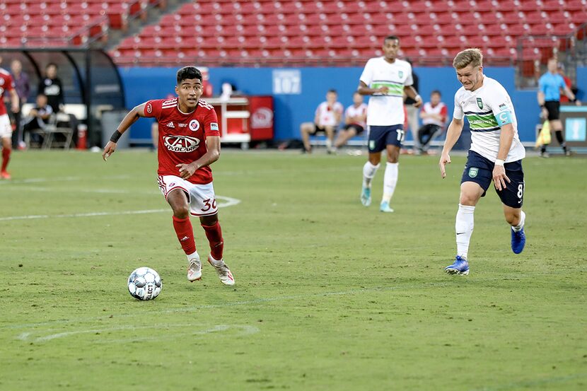 Imanol Almaguer of North Texas SC alludes Greenville's Aaron Walker in the USL League One...