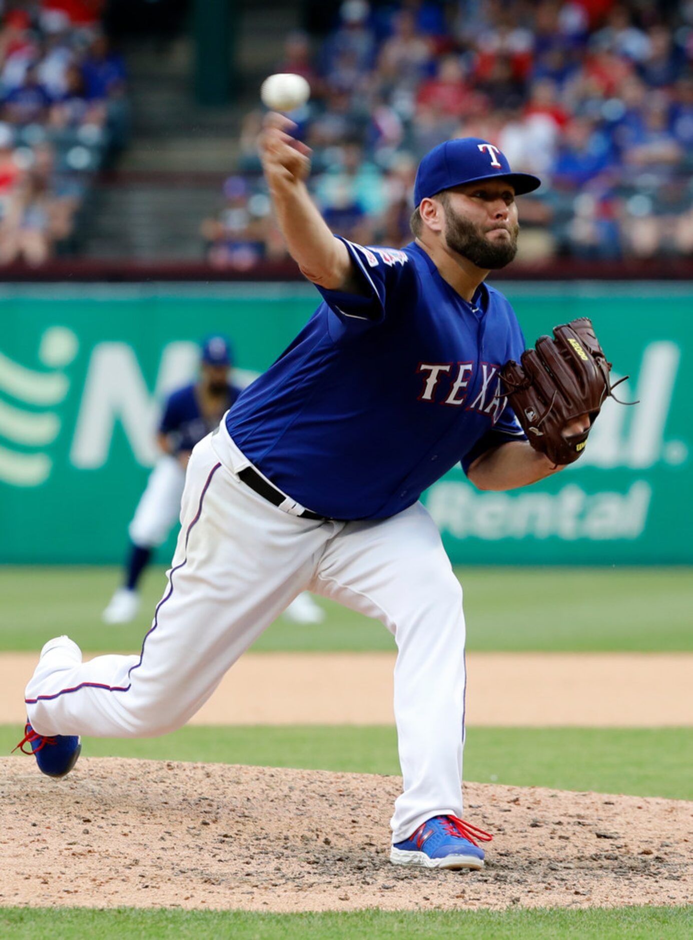 Texas Rangers starting pitcher Lance Lynn throws to the Kansas City Royals in a baseball...