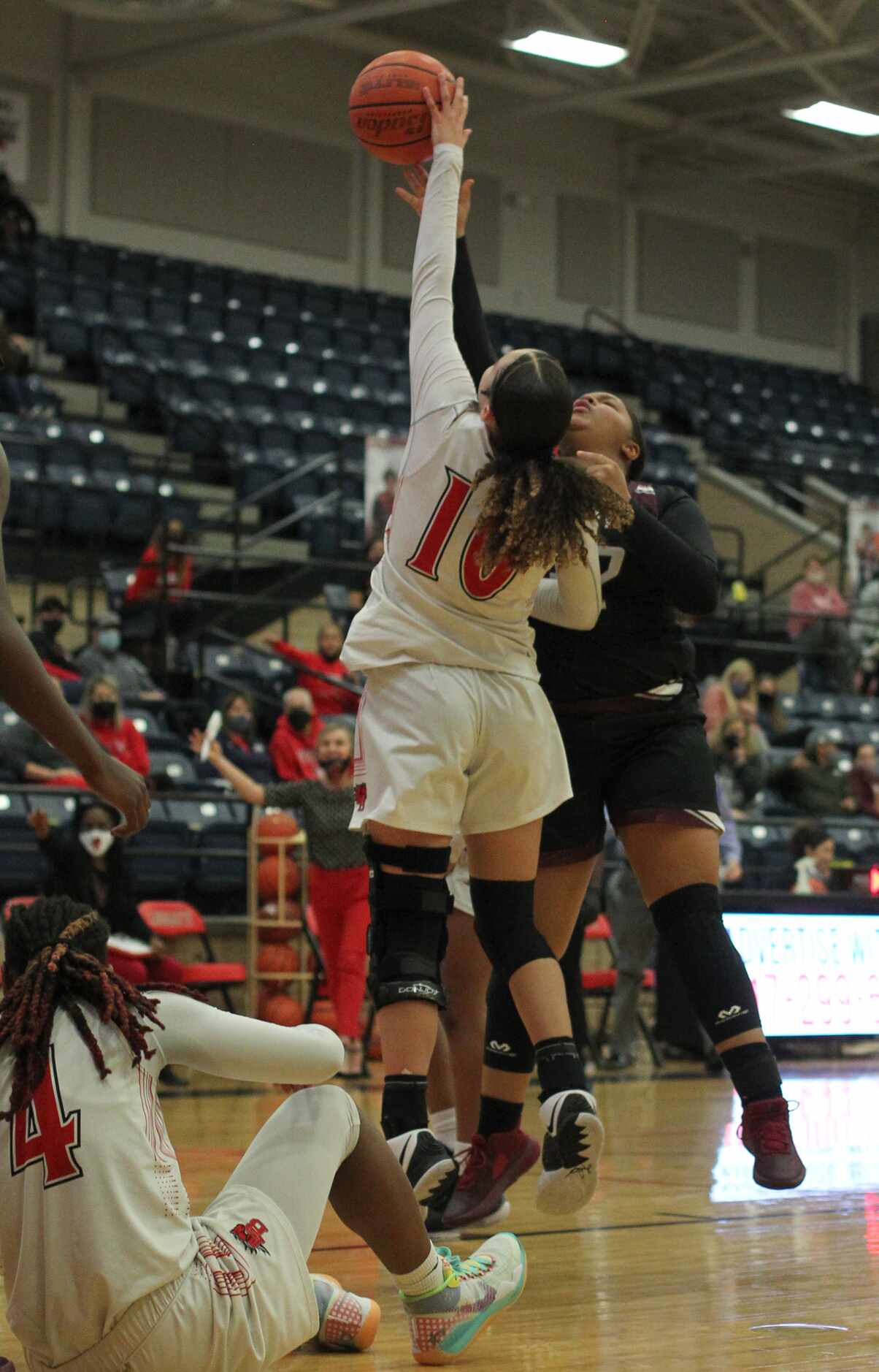 Mansfield Legacy guard Maddie Griggs (10) leaps to block a shot by Mansfield Timberview post...