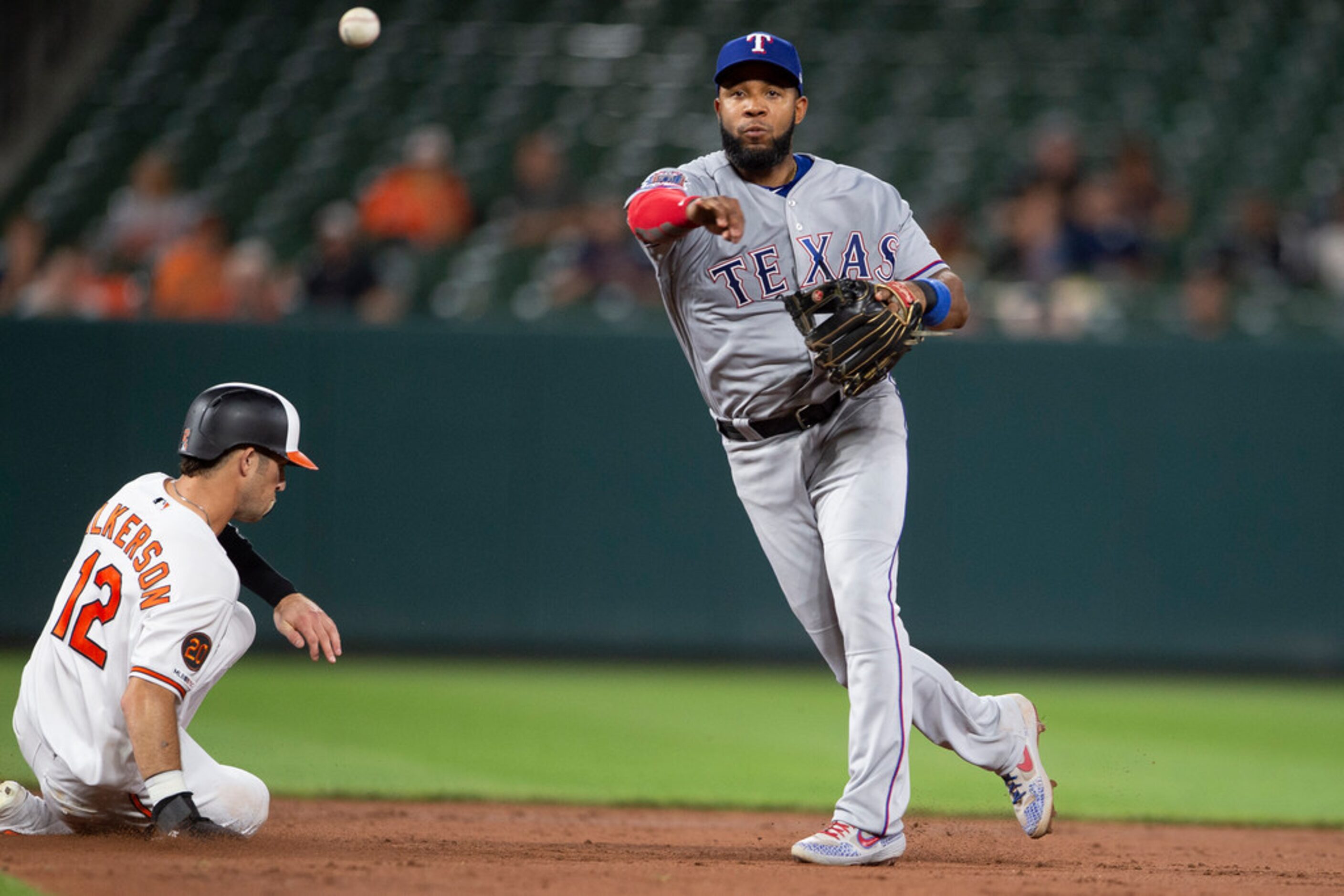 Texas Rangers shortstop Elvis Andrus throws to first base after the force out of Baltimore...