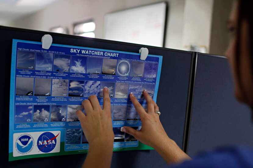 Amber Elliott, a meteorologist with the National Weather Service, identifies cloud...