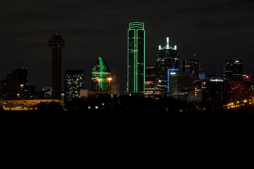 Several Dallas downtown buildings turn off their exterior lights off on Wednesday, April 21,...