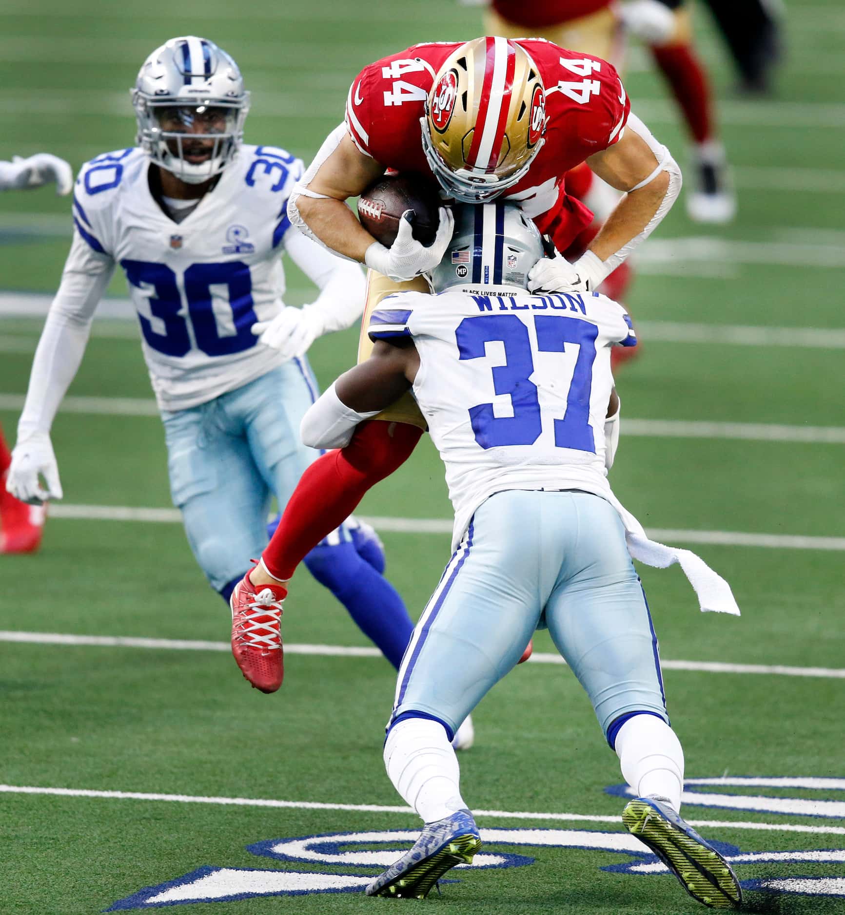 San Francisco 49ers fullback Kyle Juszczyk (44) tries to leap past the tackle by Dallas...