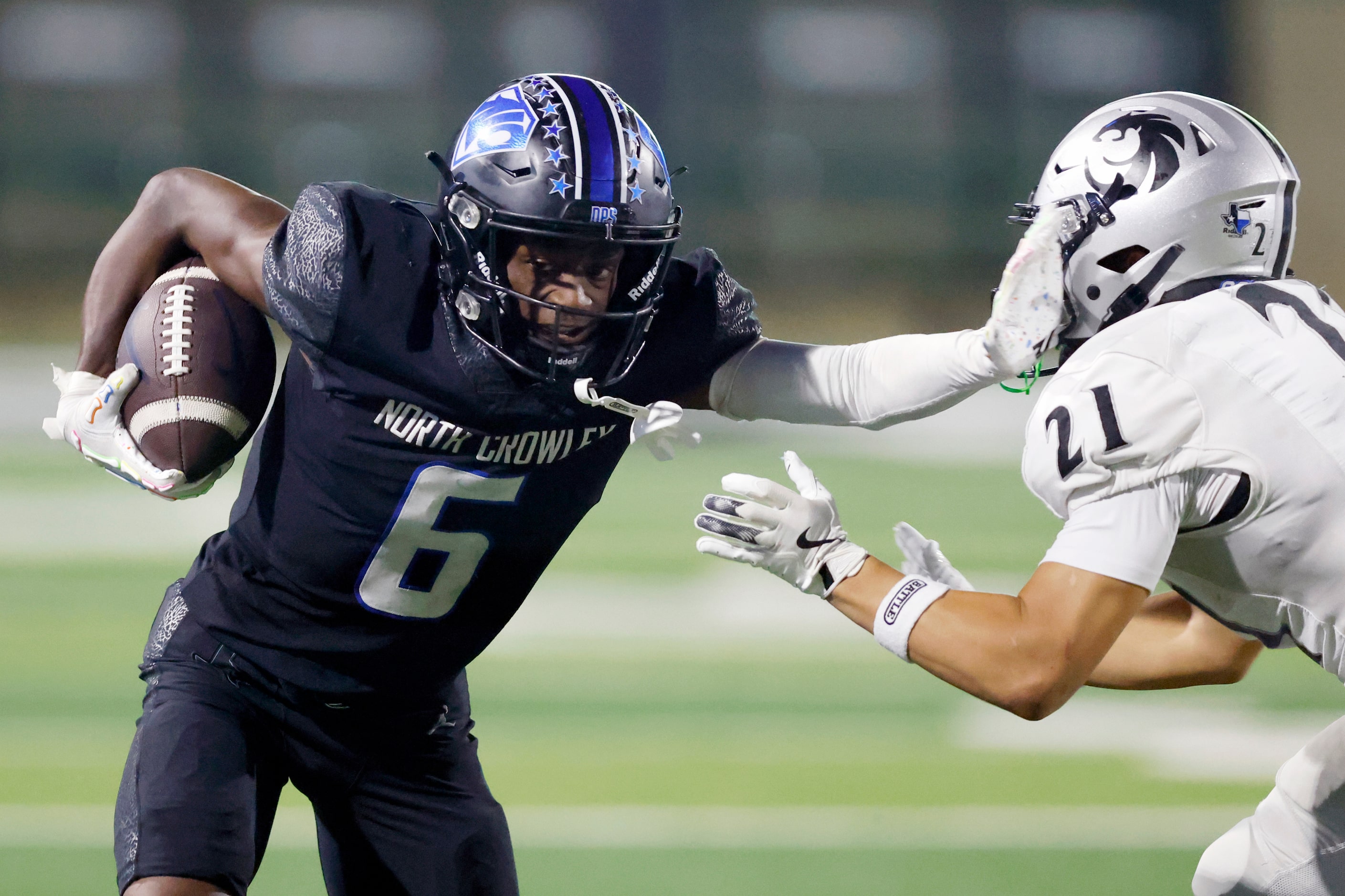 North Crowley wide receiver Quentin Gibson (6) stiff-arms Denton Guyer defensive back Jace...