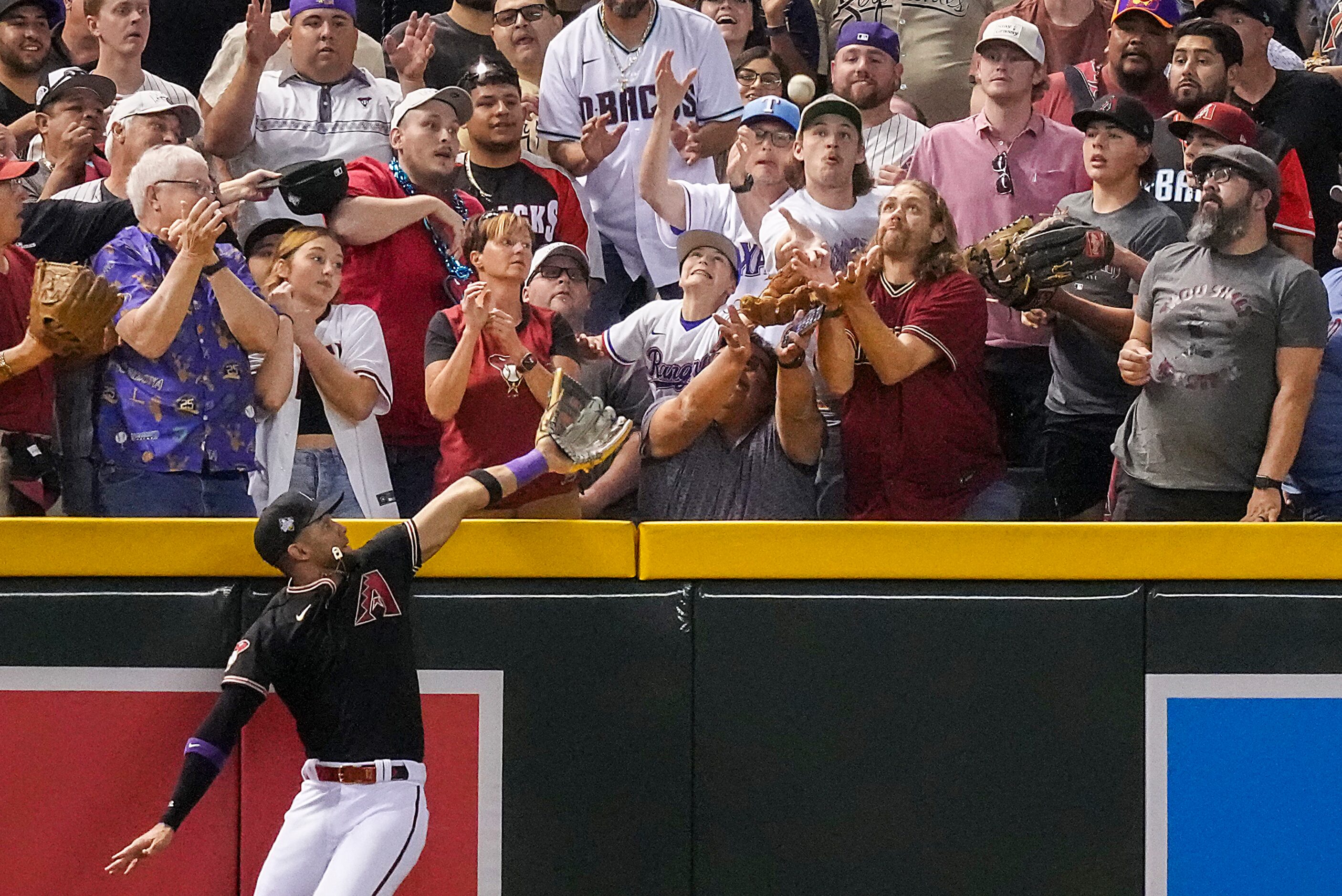 Arizona Diamondbacks left fielder Lourdes Gurriel Jr. is unable to catch a three-run home...