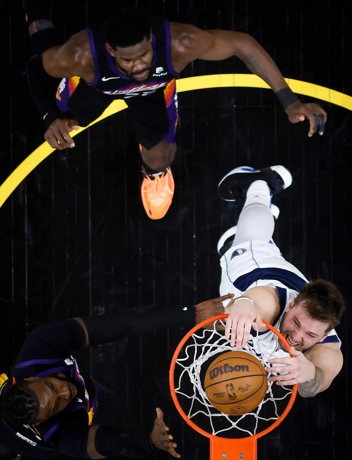 Dallas Mavericks guard Luka Doncic goes up for a dunk against Phoenix Suns forward Jae...
