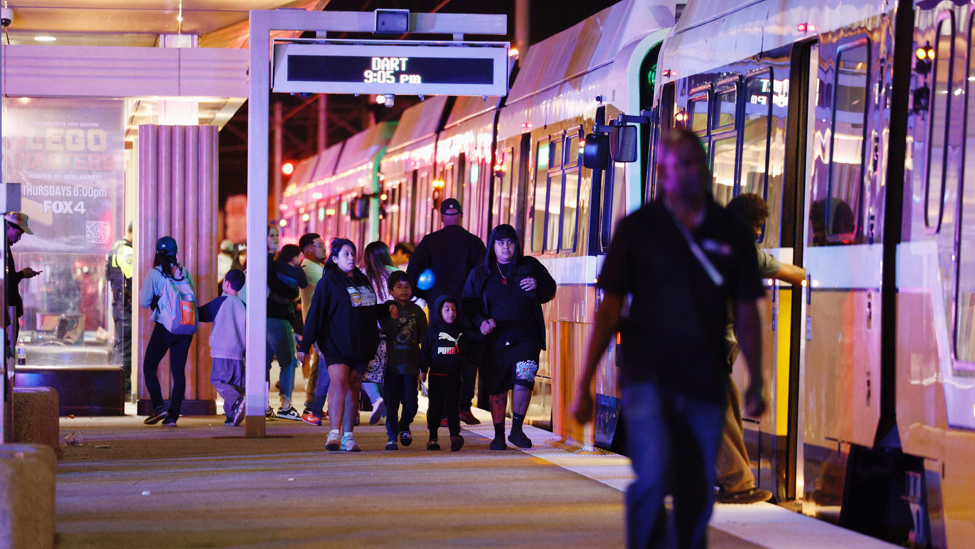 Fairgoers board a DART Light Rail at the Fair Park Station after a shooting at the State...