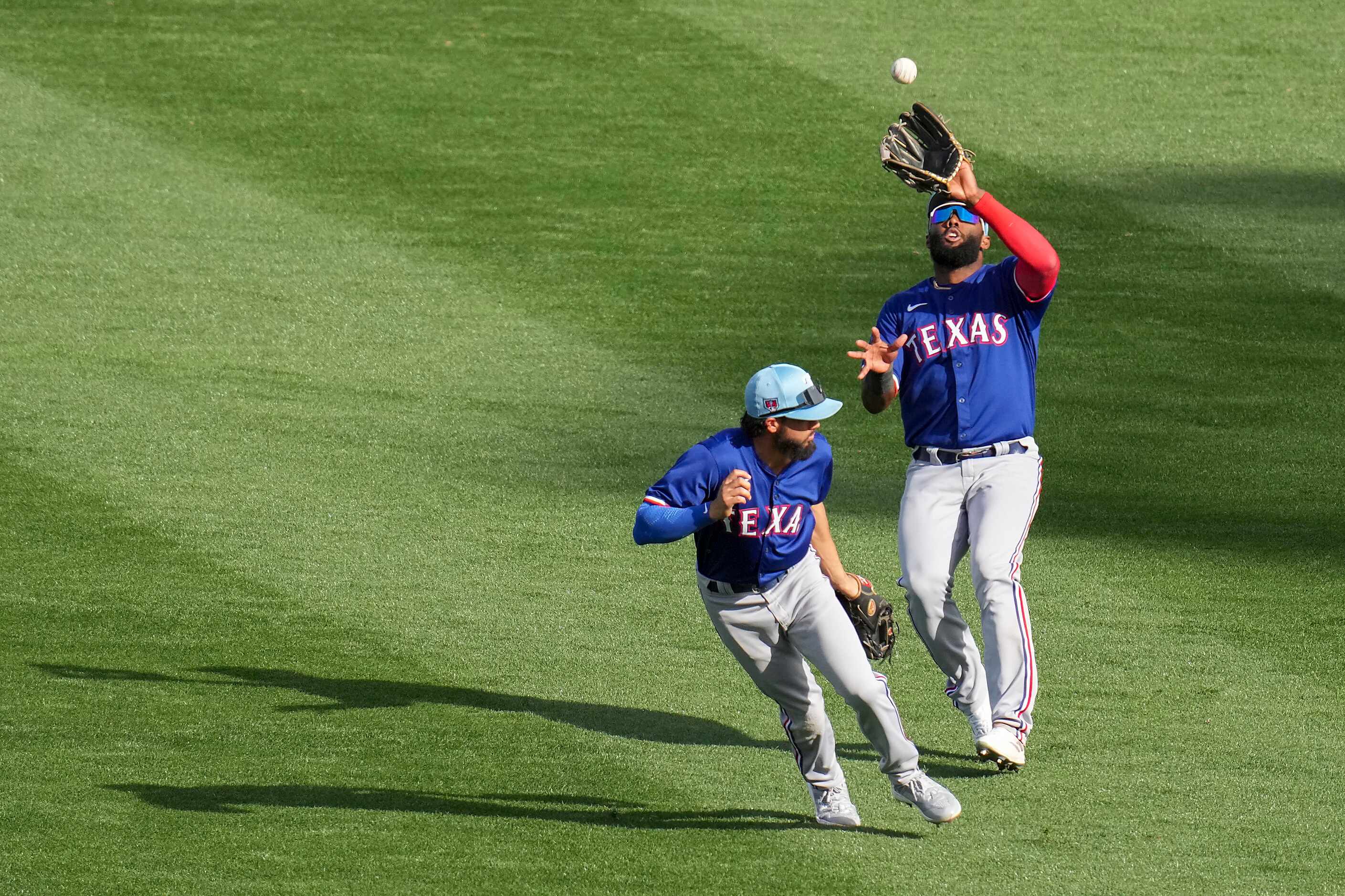 Texas Rangers outfielder Sandro Fabian avoids second baseman Jayce Easley as he catches a...