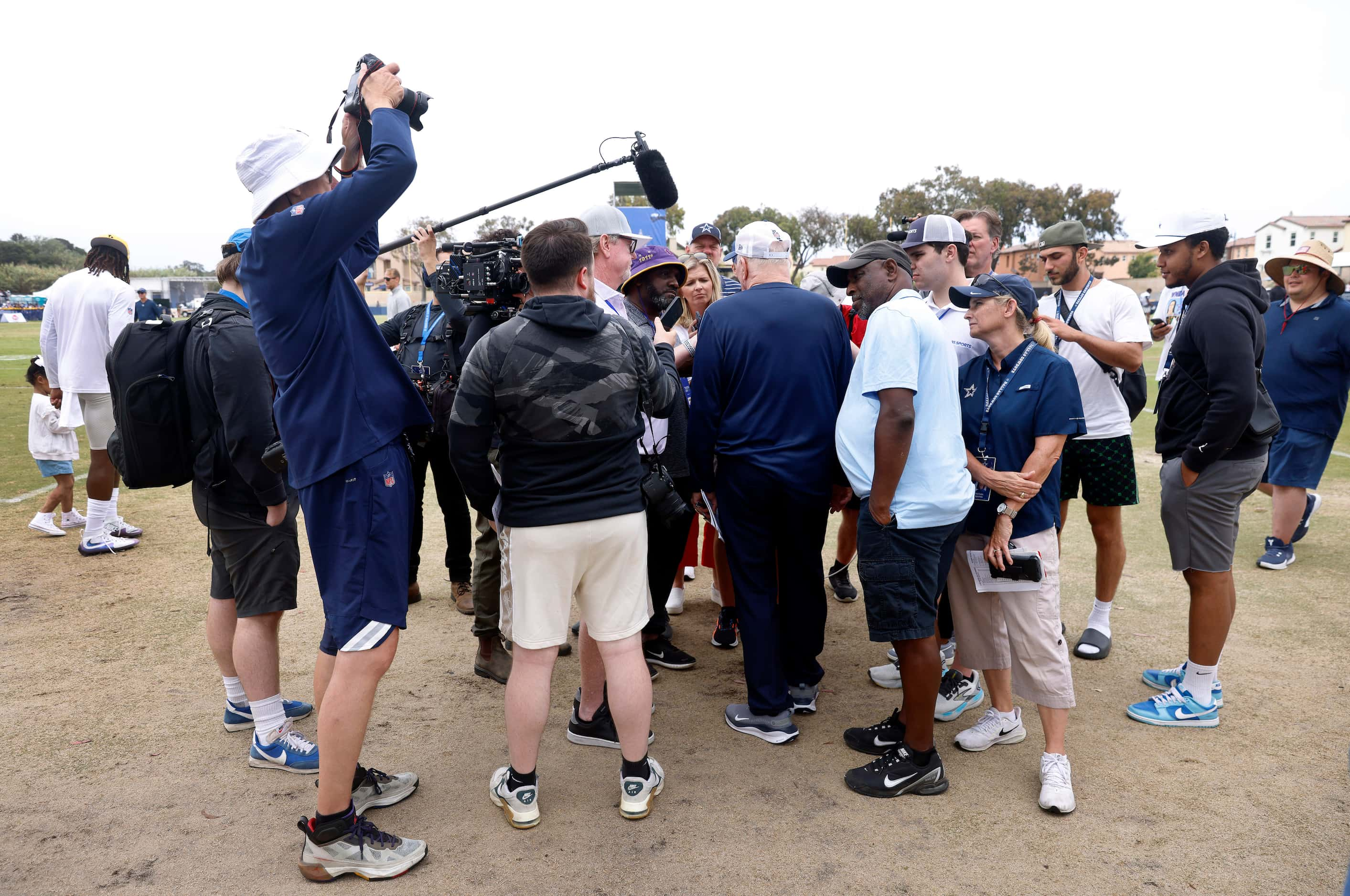 The media surrounds Dallas Cowboys owner Jerry Jones following a training camp scrimmage in...