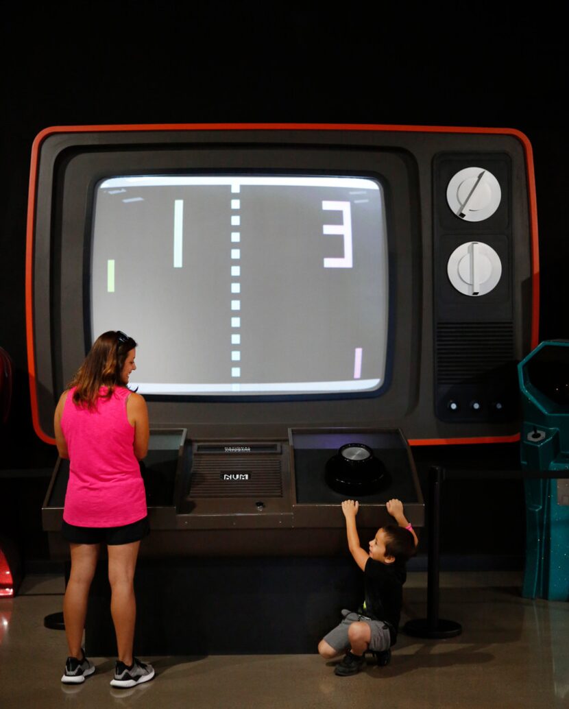 Luke Pelletier, 5, reacts after losing a round of giant "Pong" to his mother Amy Pelletier...