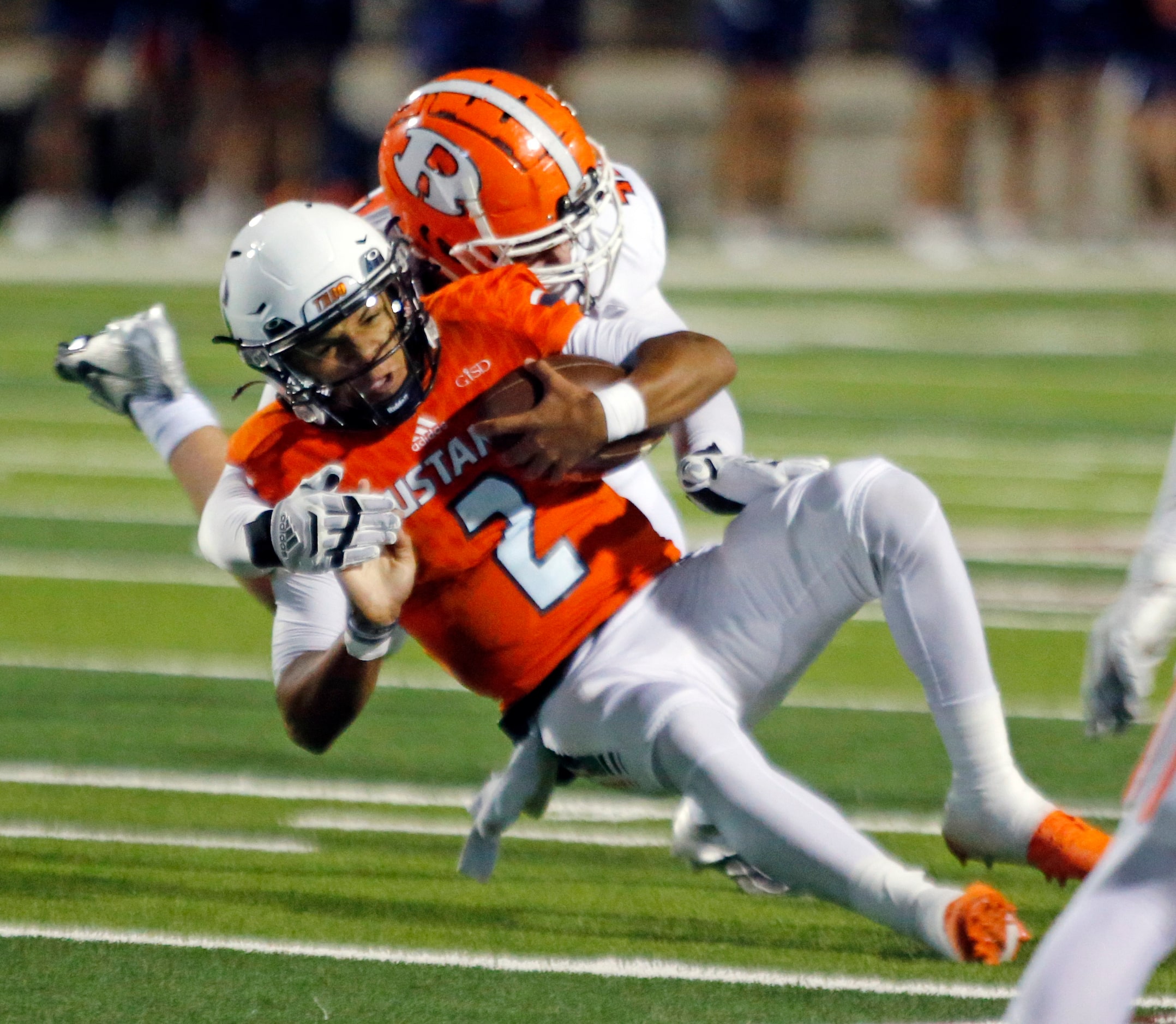 Sachse High Dirk Williams Jr. (2) is forced out of bounds by a Rockwall High defender during...