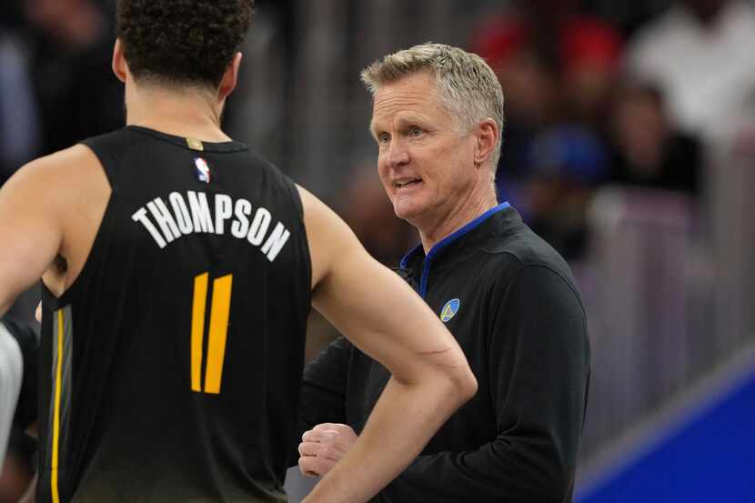 Golden State Warriors head coach Steve Kerr talks to guard Klay Thompson (11) during the...
