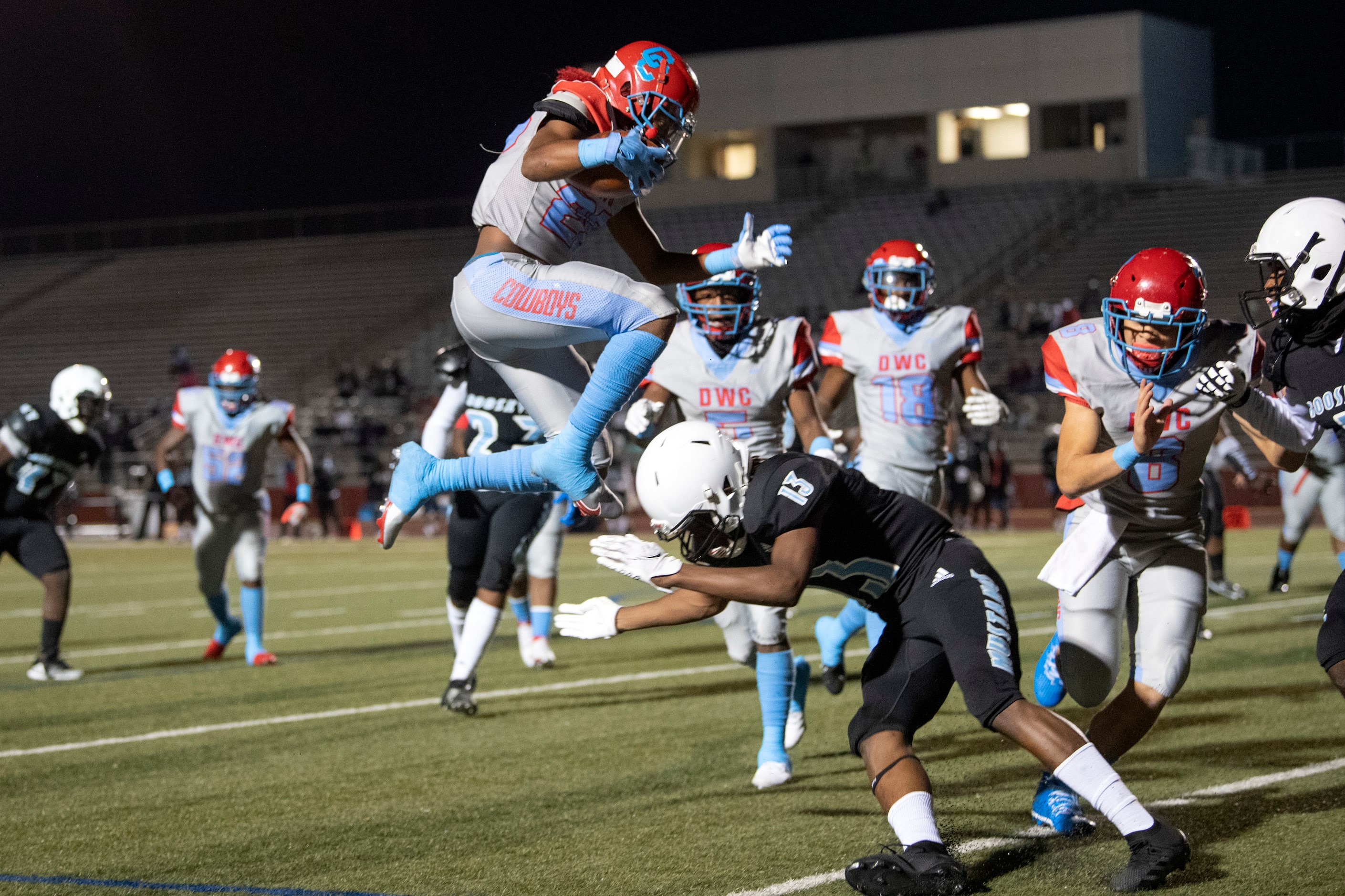 Carter junior running back Edward Robinson (28) leaps over a Roosevelt defender on a...