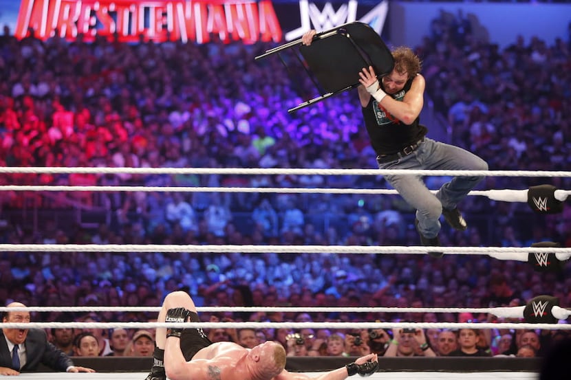Dean Ambrose, right, wrestles Brock Lesnar during WrestleMania 32 at AT&T Stadium in...