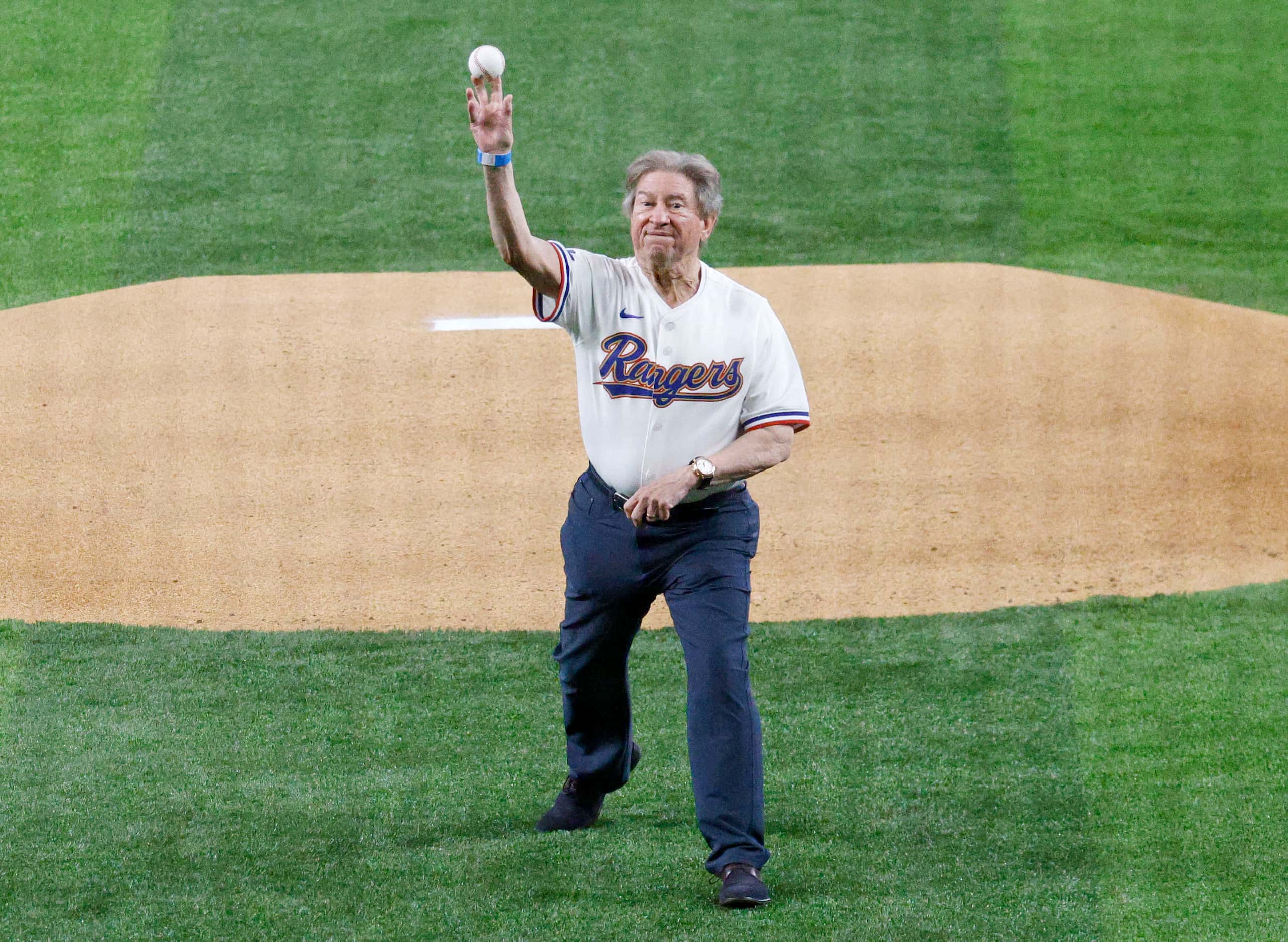 Texas Rangers fan Michael Carter of Southlake, Texas throws the ceremonial first pitch to...