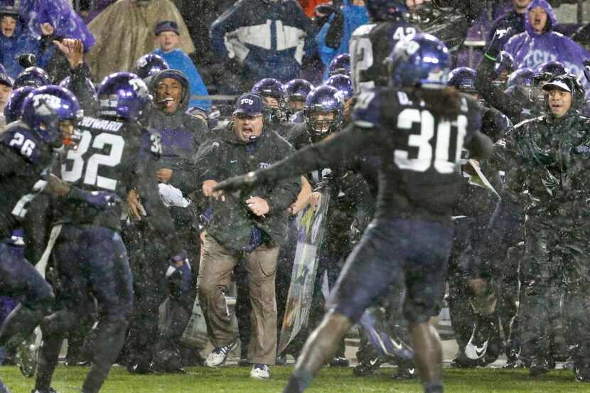 TCU head coach Gary Patterson (center) reacts as the Horned Frogs hold on downs to win 28-21...