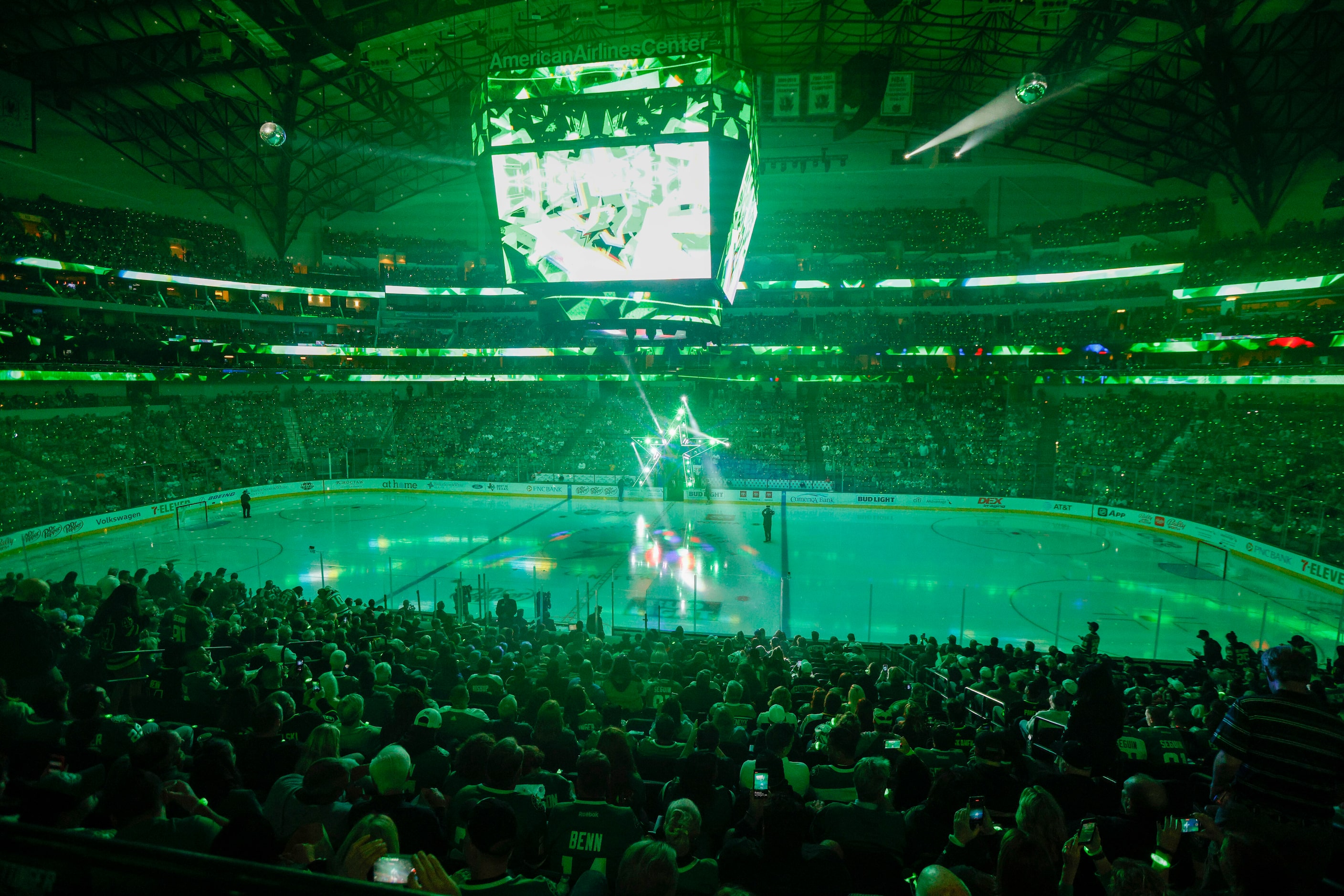 Fans watch as the Dallas Stars logo is lowered to the ice before the first period of the...