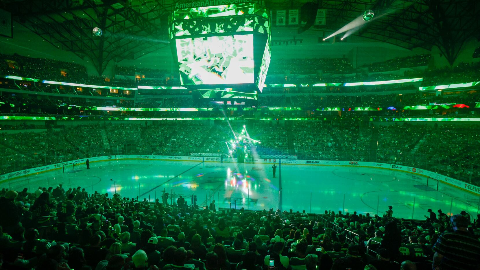 Fans watch as the Dallas Stars logo is lowered to the ice before the first period of the...