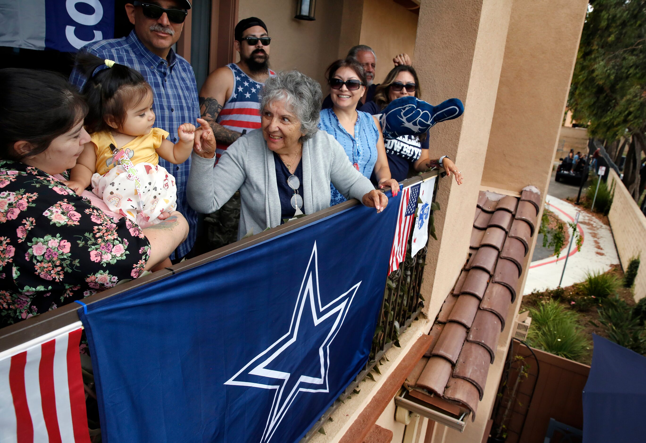 Adela Acosta receives a fist bump from 10-month old Nala as they cheered the players...