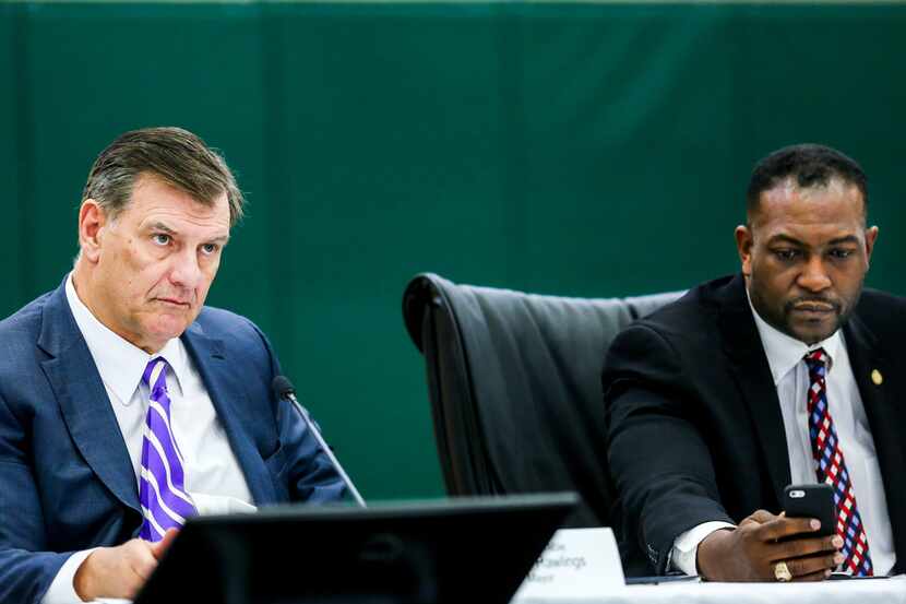 Dallas Mayor Mike Rawlings listens along with Mayor Pro Tem Casey Thomas, II, right, during...