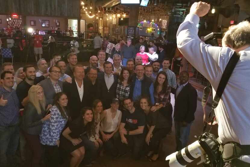 Sen. Ted Cruz, arm around campaign manager Jeff Roe, poses with his campaign staff after his...