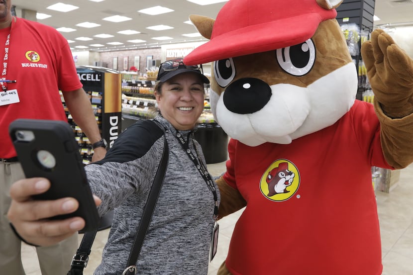 Tania Cortez takes a selfie with the Buc-ee's beaver mascot at the new Buc-ee's in Melissa,...