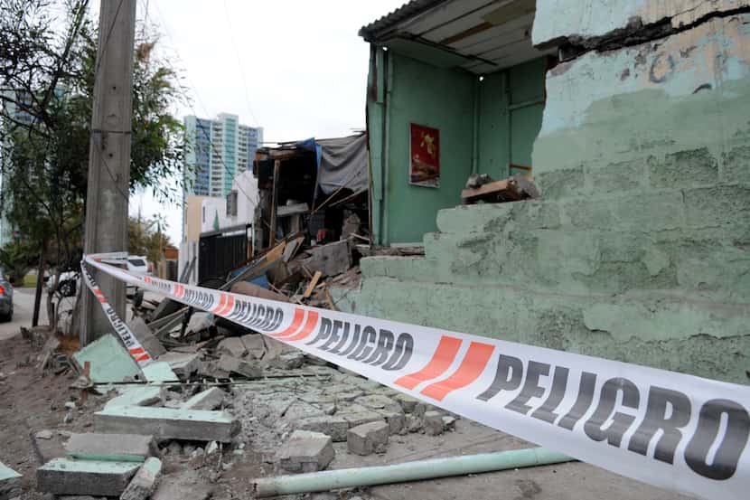White barricade tape that reads in Spanish; "Danger," blocks off damage caused overnight in...