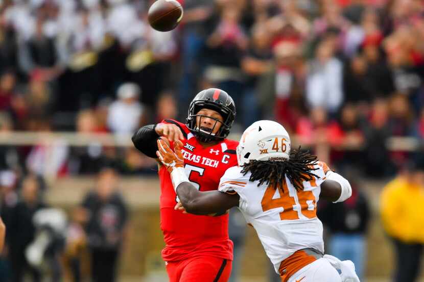Texas Tech quarterback Patrick Mahomes II  passes  while under pressure from Texas...