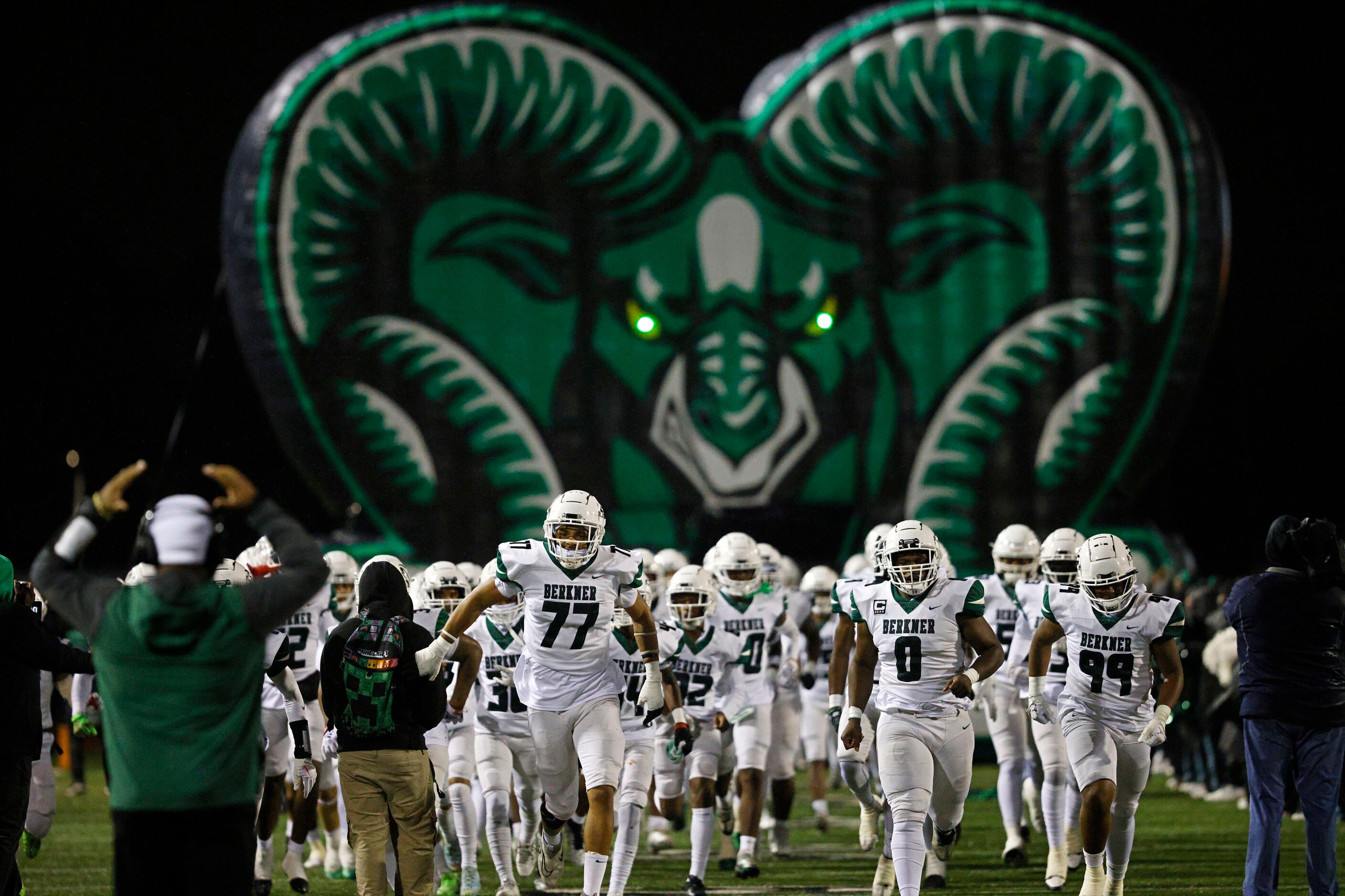 Berkner players run into the field before a high school Class 6A Division I bi-district...