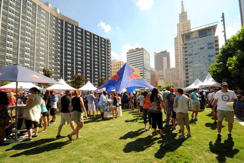 Festival-goers wander around Main Street Garden on a sunny afternoon in downtown Dallas. 