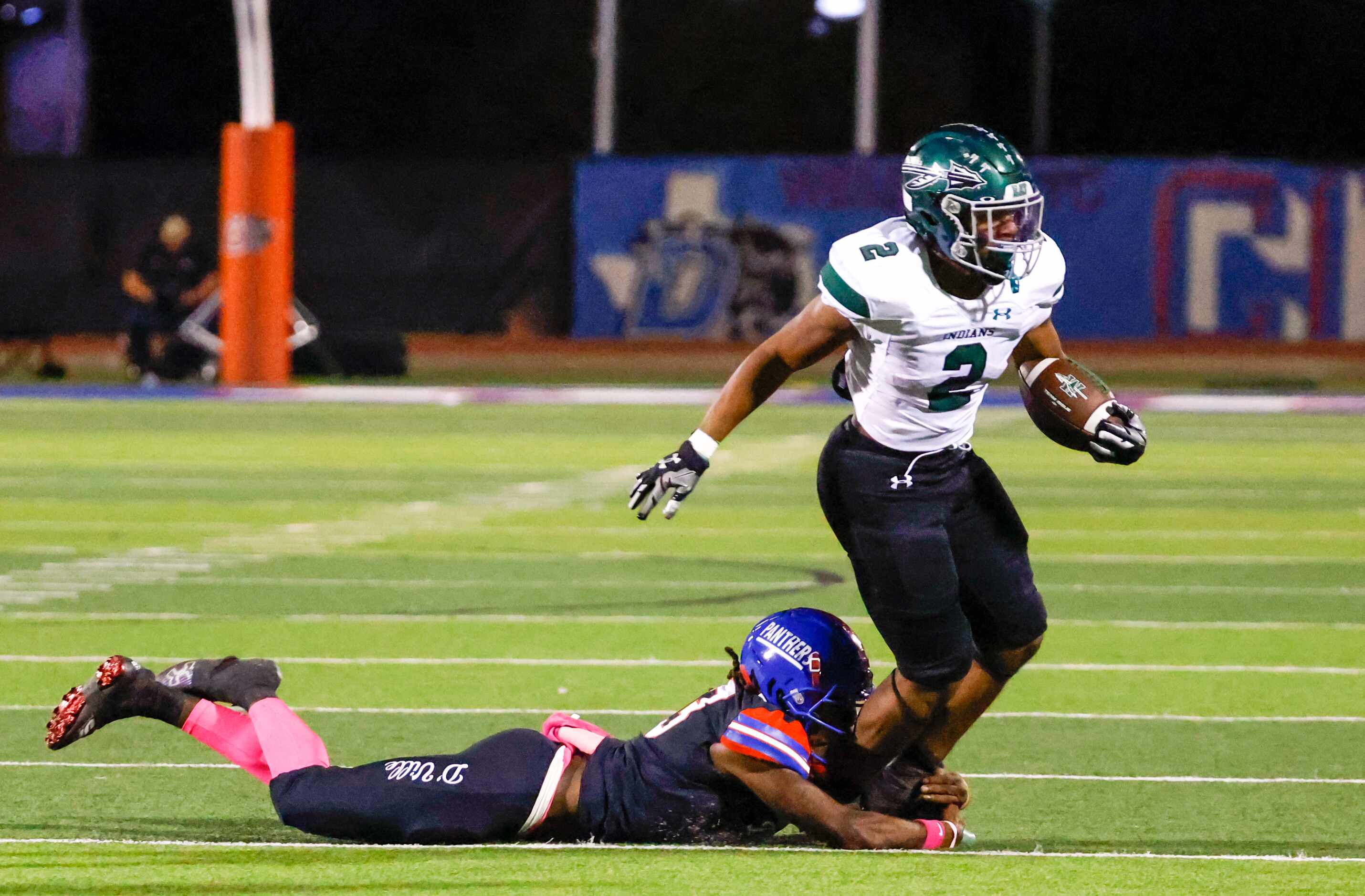 Waxahachie running back Iverson Young (2) is tackled by Duncanville athletic Del’Drik...