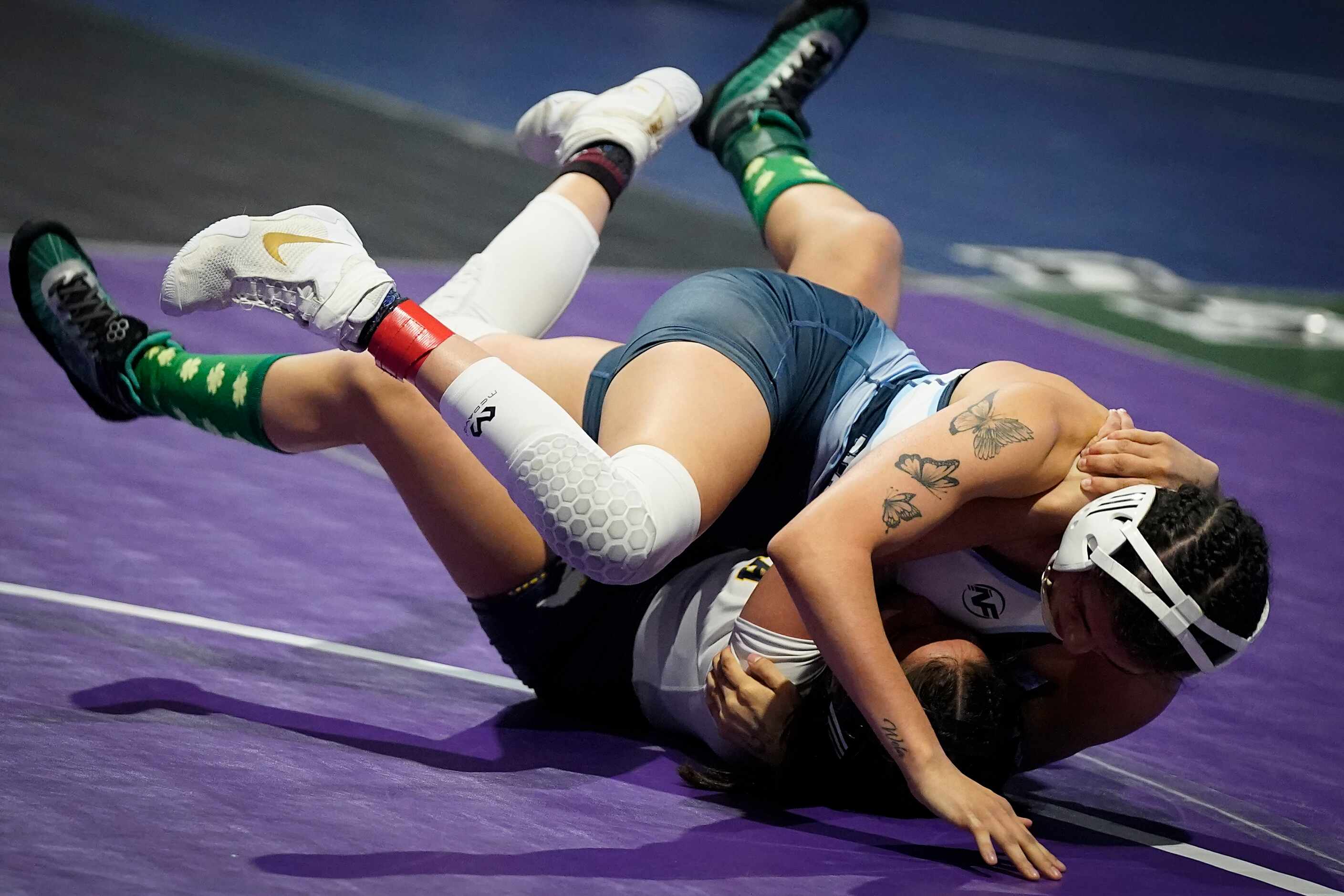 Devin Patton of Plano West (top) wrestles ayden Bazemore of Cypress Ranch for the 6A girls...