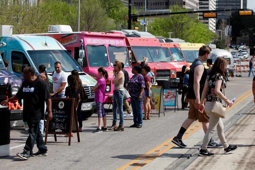 A row of food trucks block Olive Street during the Food Truck Frenzy, Saturday, March 18,...
