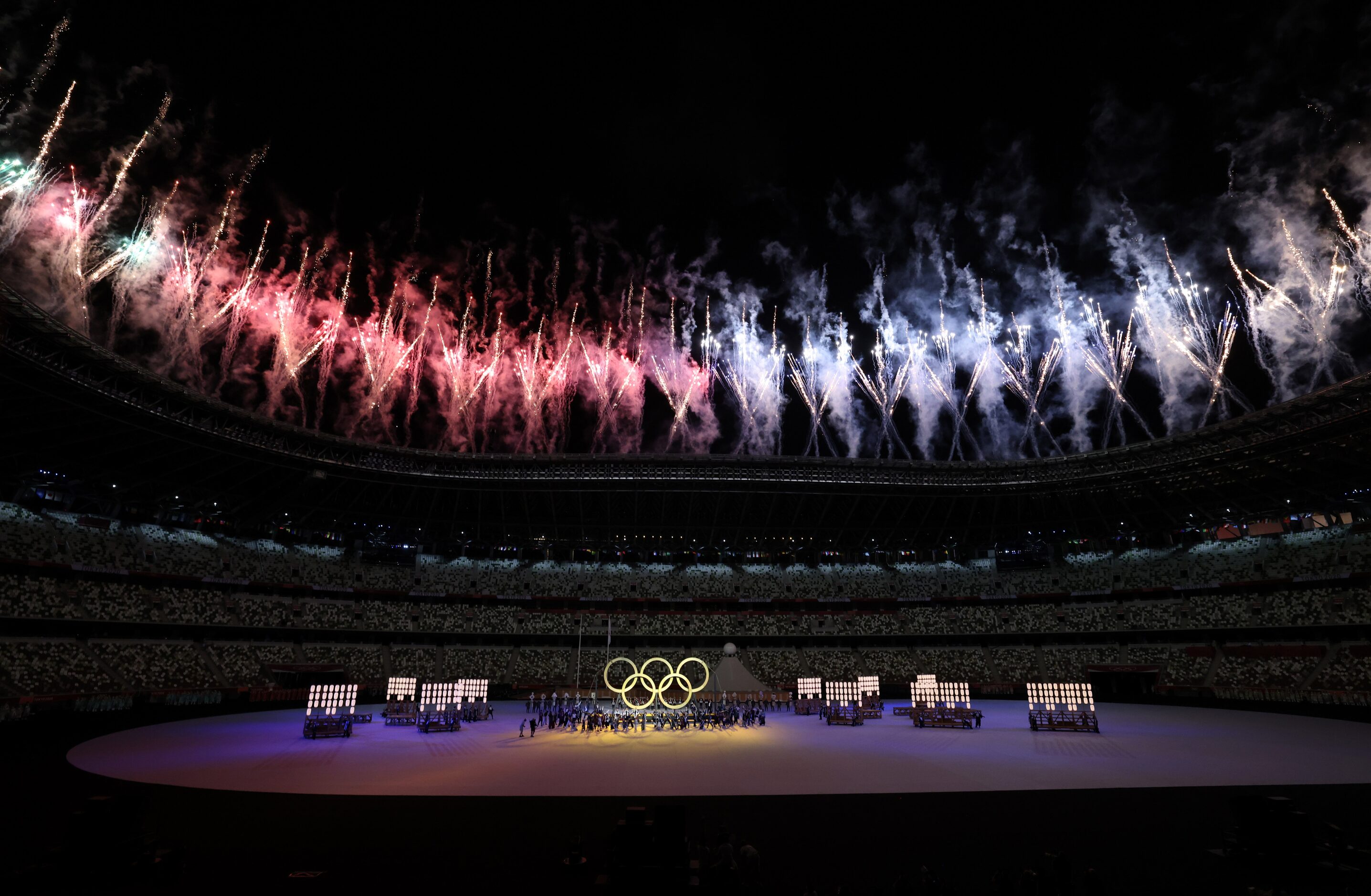 Fireworks go off as the Olympic rings are shown during the opening ceremony for the...